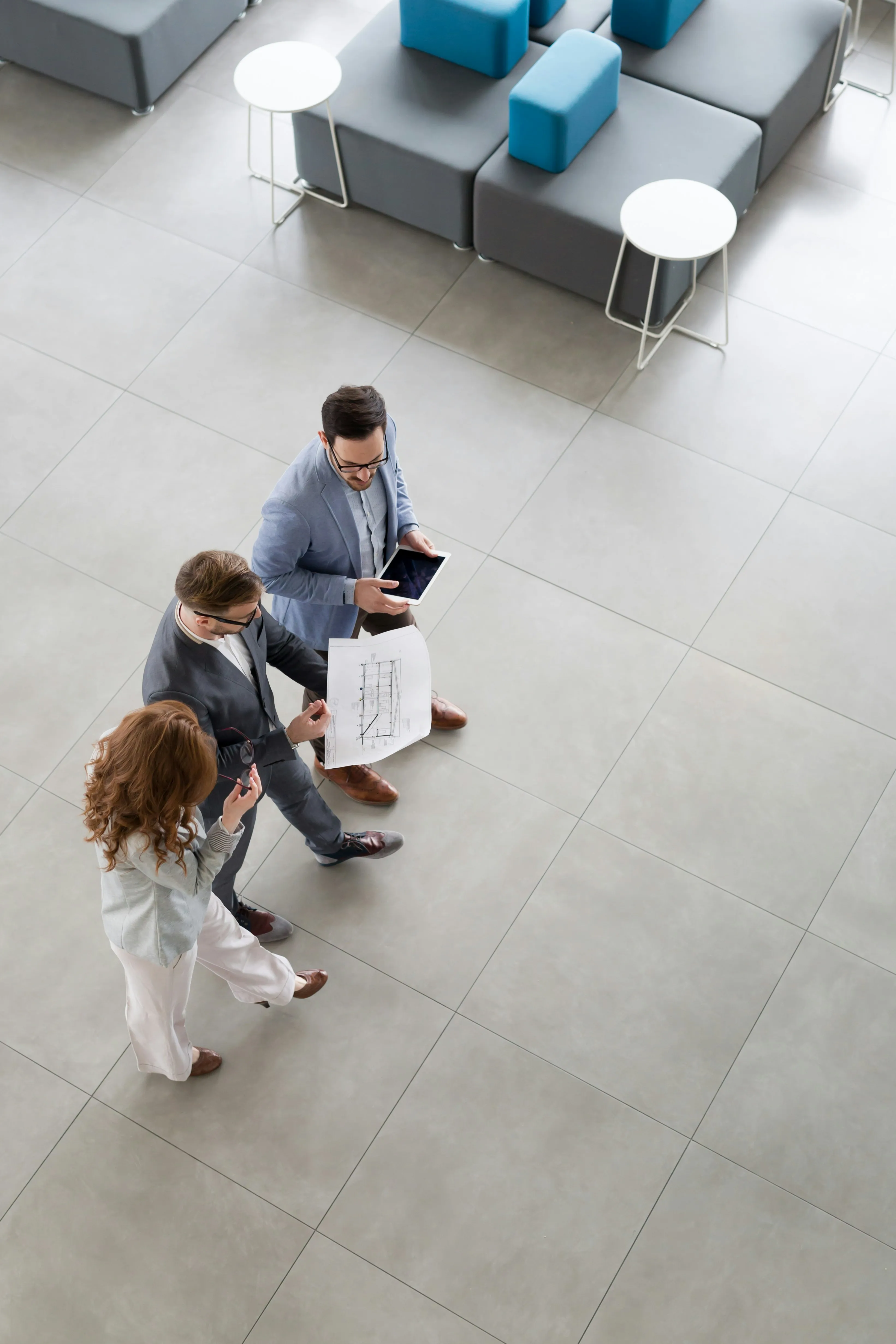 Business professionals reviewing operations data in corporate lobby
