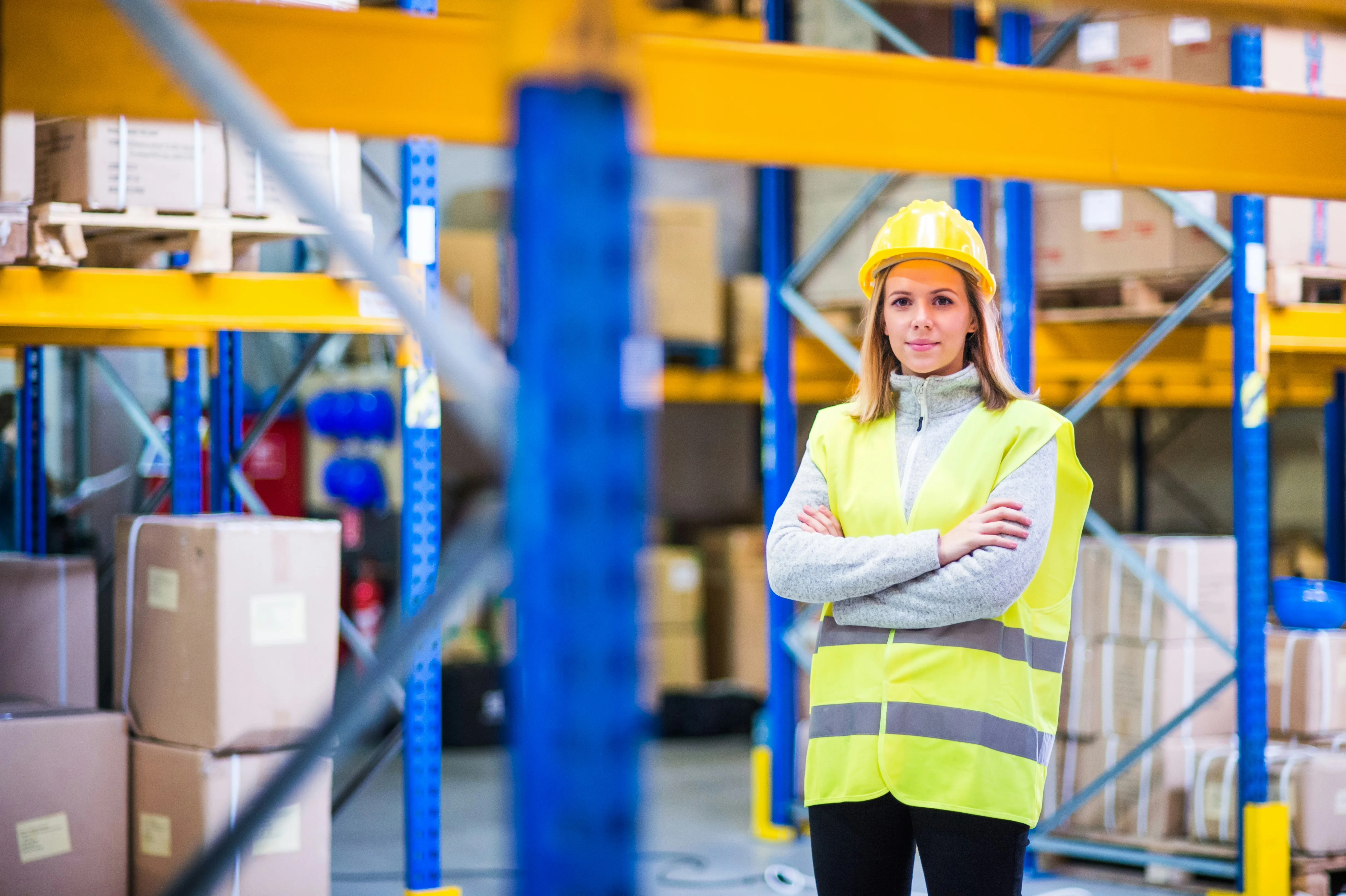 Confident warehouse leader standing with arms crossed