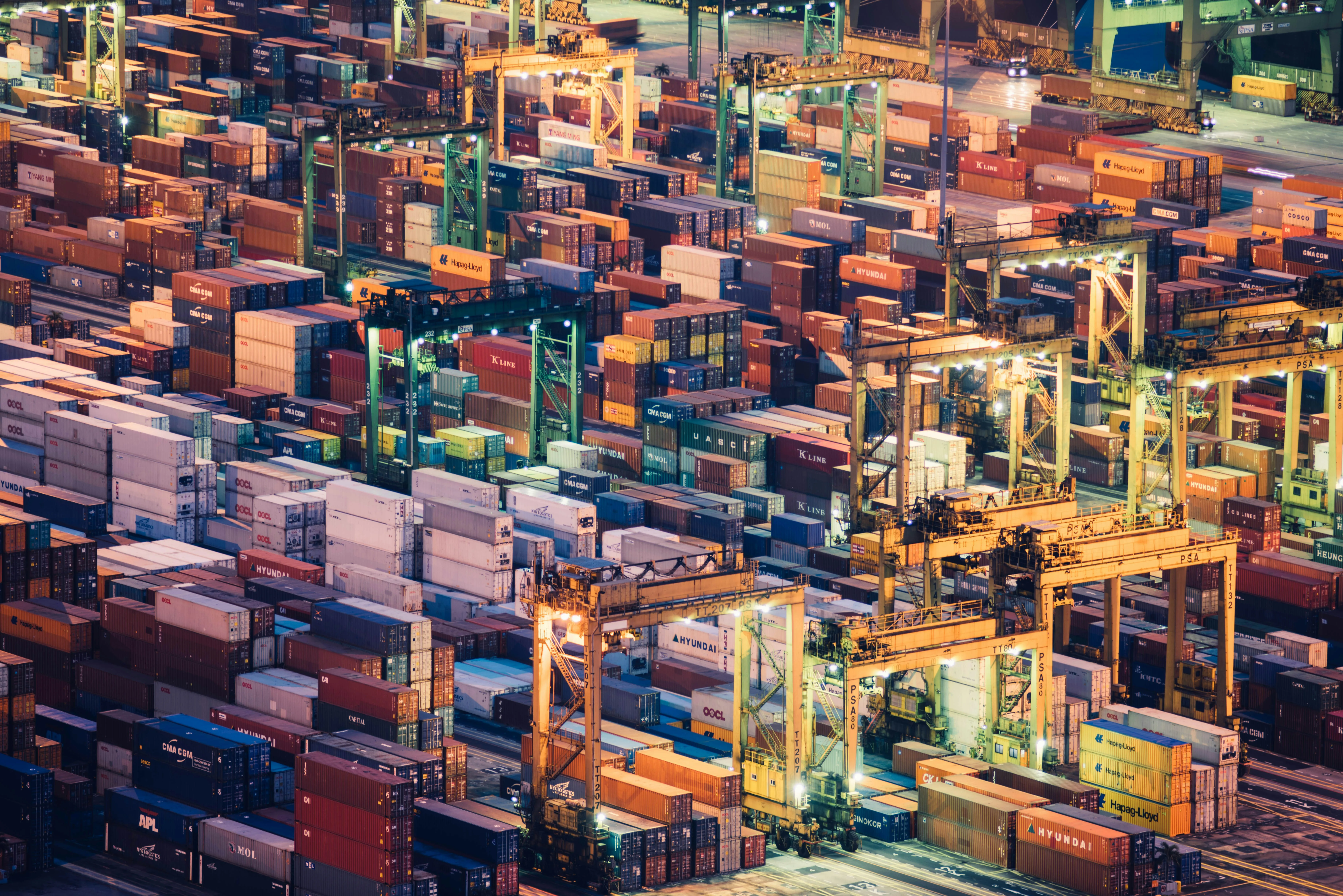 Container port operations at night with illuminated cranes
