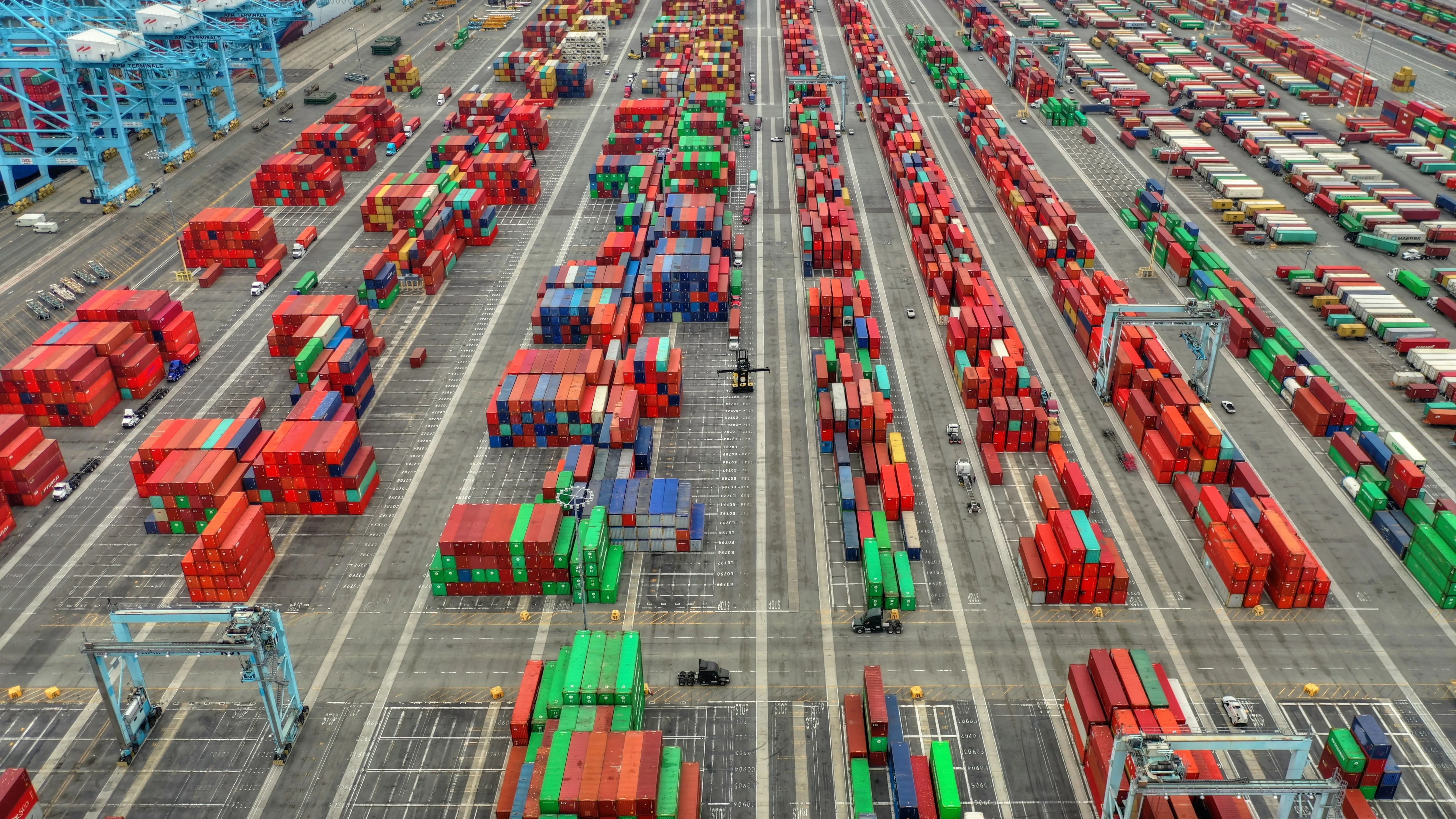 Aerial view of massive container terminal with thousands of containers and gantry cranes
