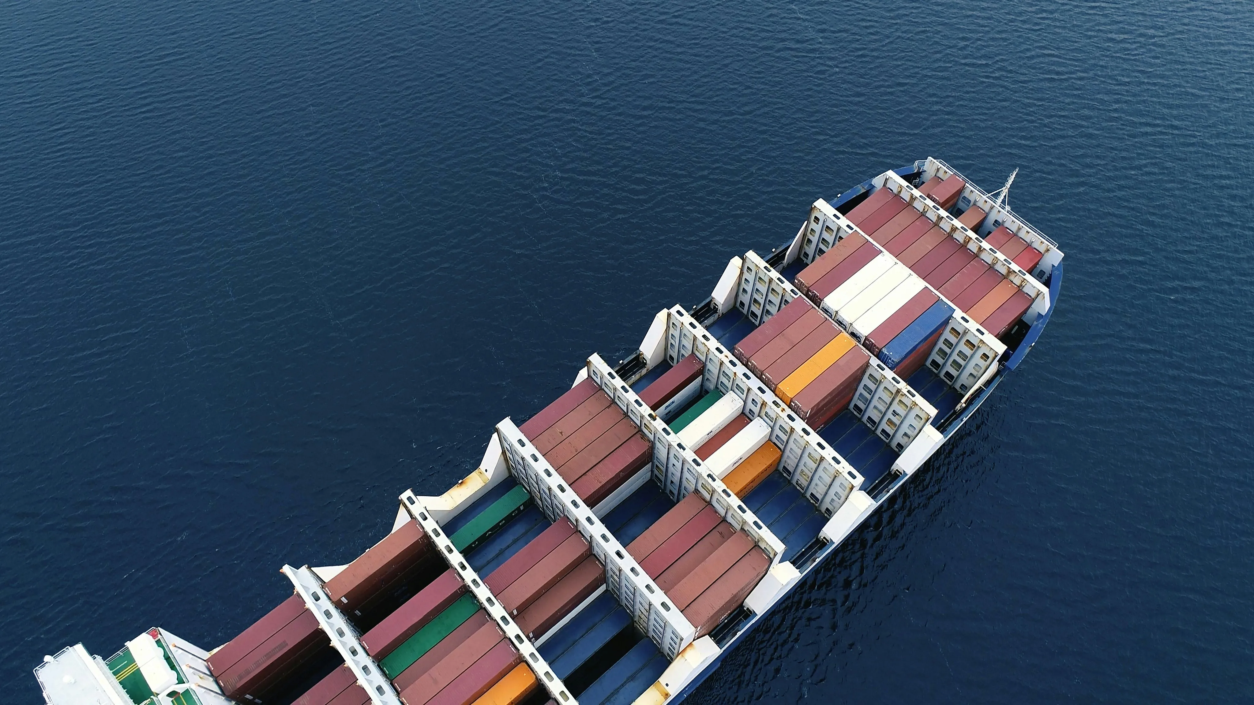 Aerial view of container ship loaded with cargo at sea