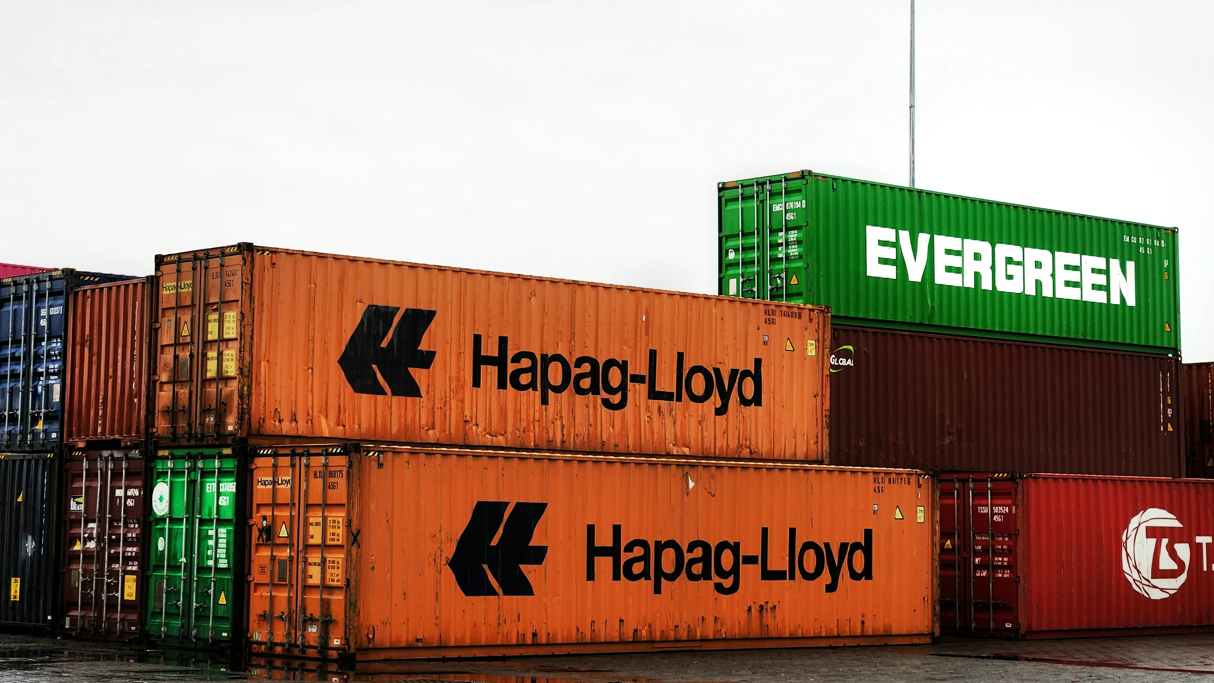 Branded shipping containers stacked at port depot