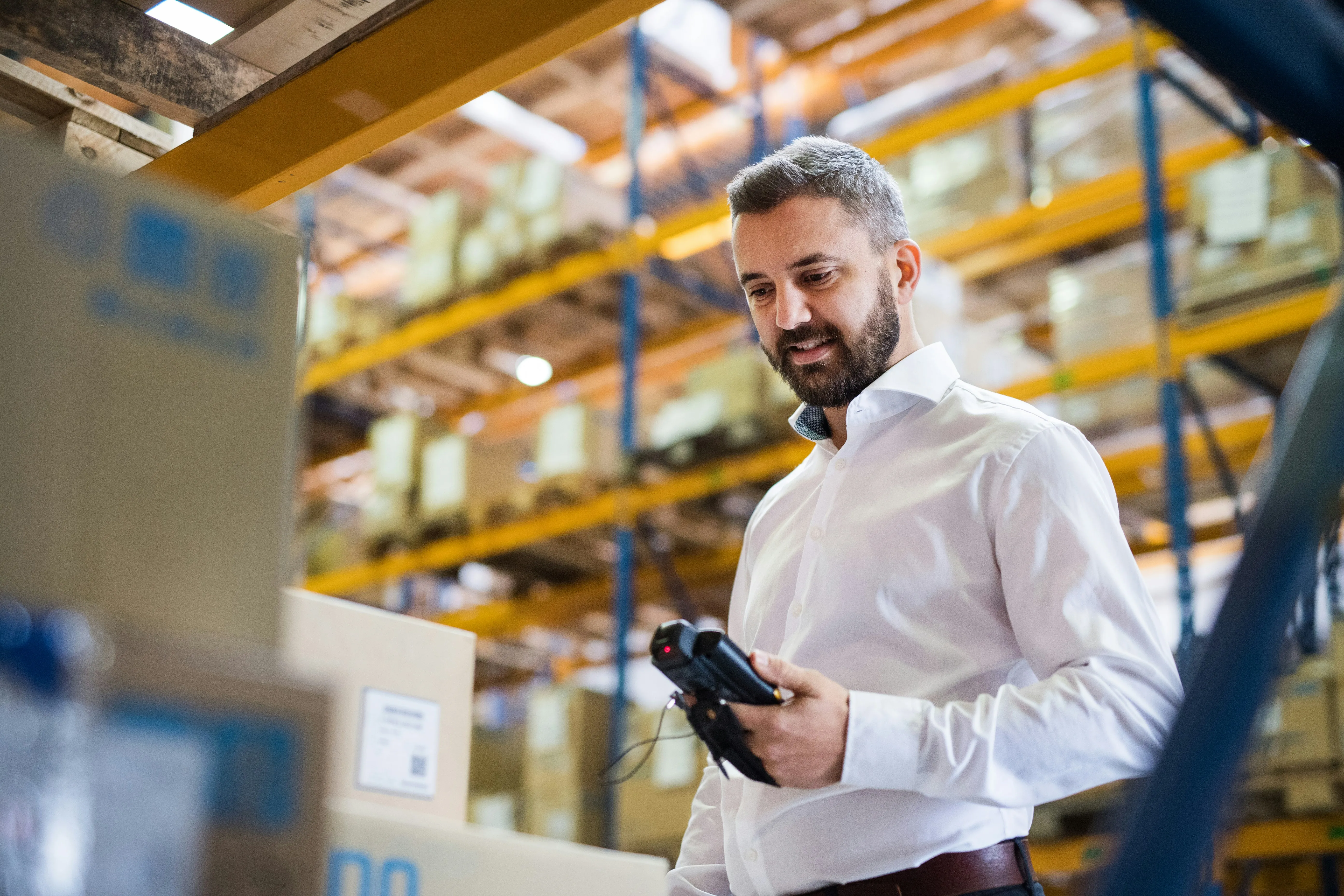 Manager scanning inbound shipment with barcode scanner