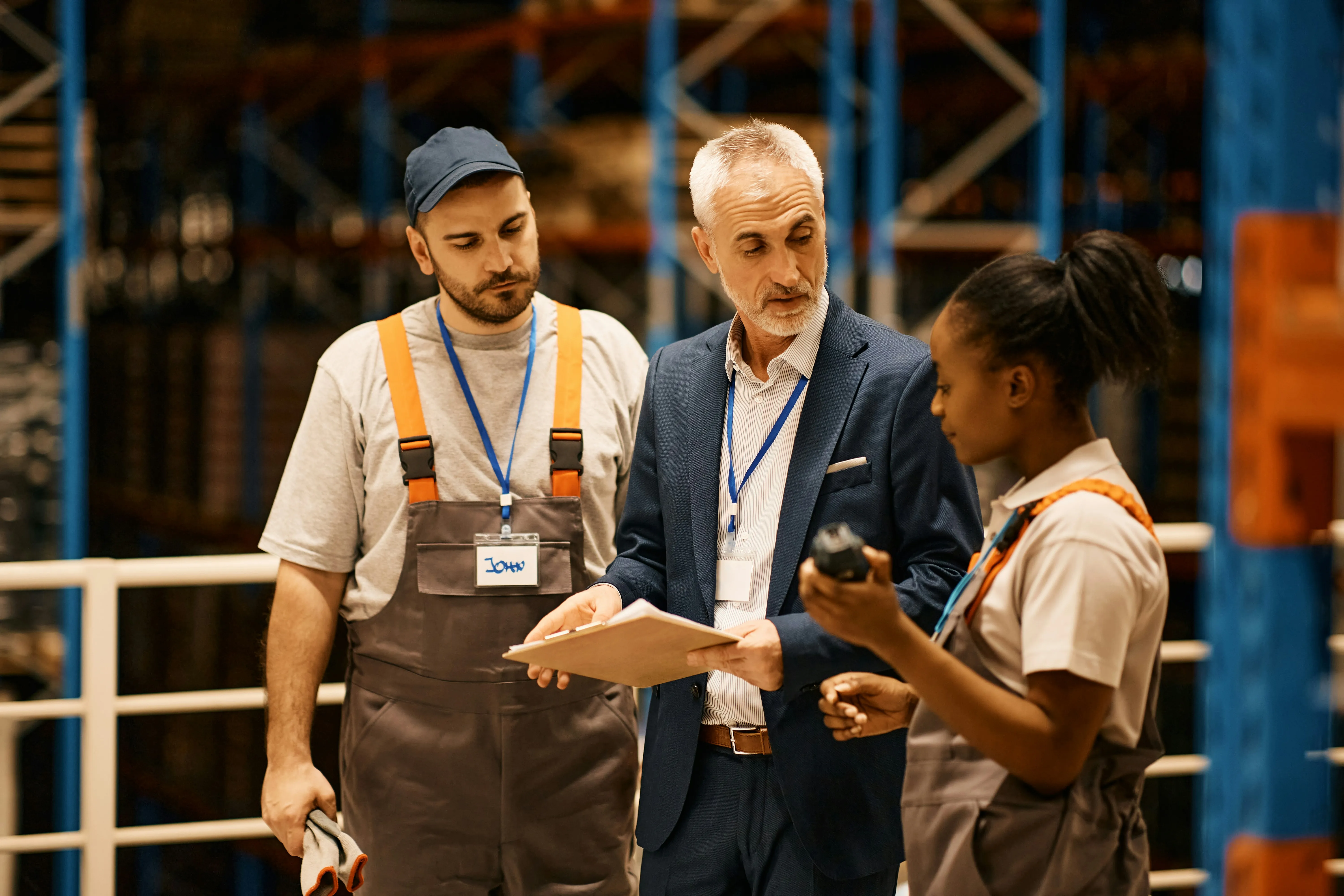 Manager in suit briefing warehouse team