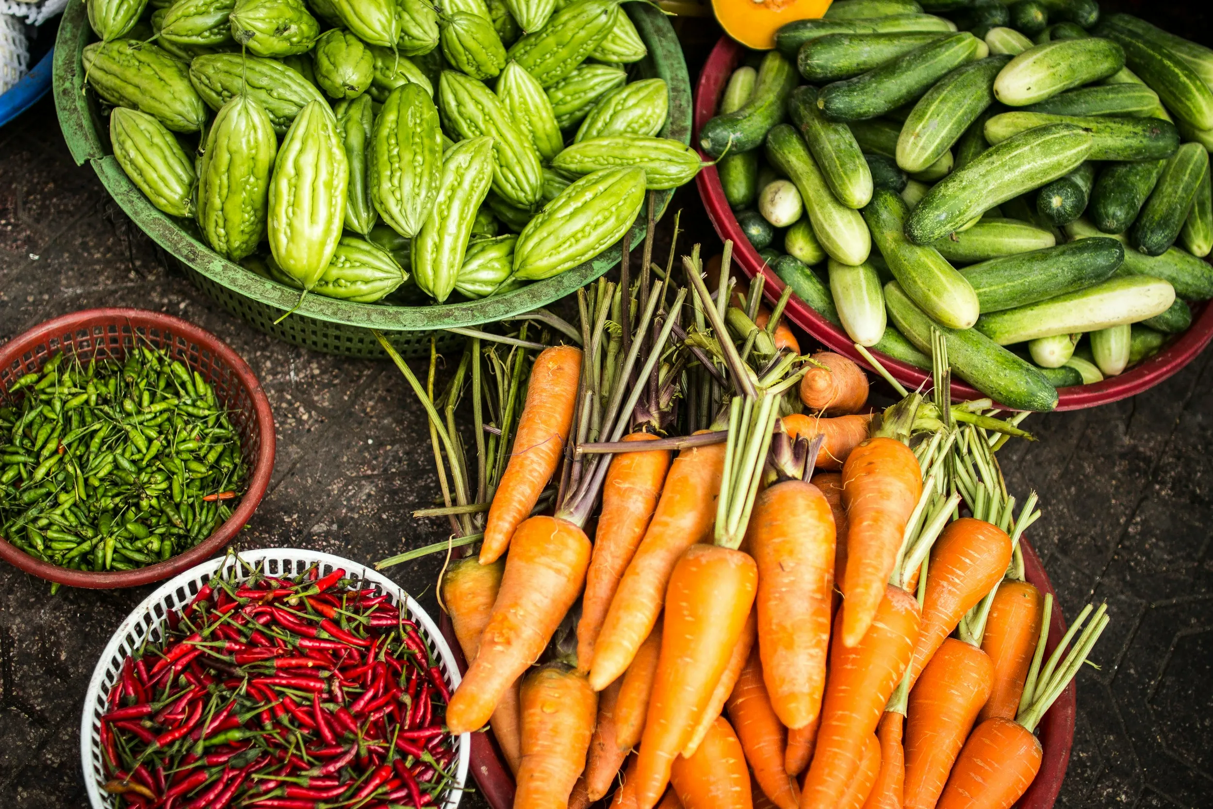 Overhead view of colorful fresh vegetables at a market stall
