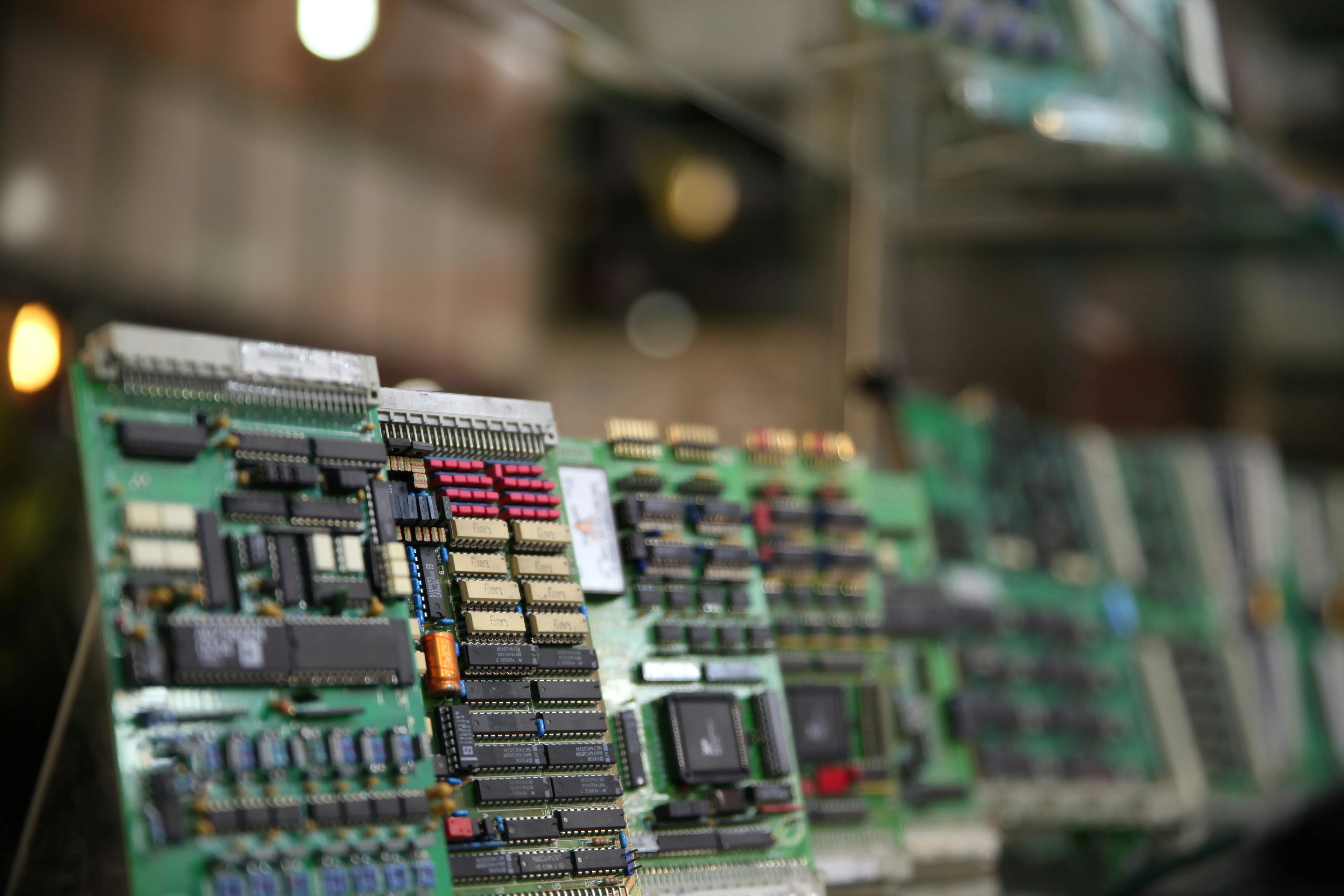 Circuit boards on rack in dimly lit electronics factory